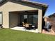 Covered patio with seating area and grassy backyard at 2121 Cold Canyon Ave, North Las Vegas, NV 89086