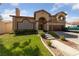 Two-story home with three-car garage and landscaped yard at 8713 W Gilmore Ave, Las Vegas, NV 89129