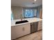 Modern kitchen with white quartz countertops, a large sink, and stainless steel appliances at 3032 Stern Dr, Las Vegas, NV 89117