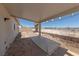 Covered patio with stone tile flooring and a view of the backyard at 2888 Cattail Cove St, Laughlin, NV 89029