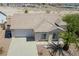 Single-story house with attached garage, landscaping, and desert plants at 2888 Cattail Cove St, Laughlin, NV 89029