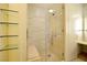 Spa-like shower with glass enclosure, built-in seat, and glass shelving at 3726 Las Vegas Blvd # 309, Las Vegas, NV 89158