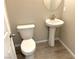 Simple bathroom with pedestal sink and toilet at 4740 Illustria Ave, Las Vegas, NV 89141