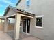 Tan house exterior with covered patio and sliding glass doors at 4740 Illustria Ave, Las Vegas, NV 89141