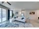 Living room with white sectional sofa and sliding glass doors to backyard at 4211 Callisto Ave, North Las Vegas, NV 89084