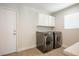 Laundry room with a washer, dryer, and cabinets at 9028 Firebird Dr, Las Vegas, NV 89134