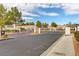 Gated entrance to community with paved road and landscaping at 8752 Reef Island Ct, Las Vegas, NV 89147