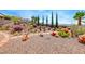 Landscaped backyard with gravel, stone pathway, and desert plants at 2428 Hydrus Ave, Henderson, NV 89044