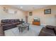 Living room with dark leather furniture and a glass-top coffee table at 1430 Red Rock Dr, Pahrump, NV 89048