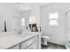 Bathroom featuring vanity with sink, a toilet, and a large mirror at 7013 Fossil Rim St # 0, North Las Vegas, NV 89084