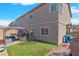 Backyard featuring artificial turf, patio seating, and a sliding glass door into the home at 7013 Fossil Rim St # 0, North Las Vegas, NV 89084