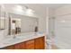 Main bathroom with double vanity, large mirror, and bathtub at 6741 Kyle Stewart Ct, North Las Vegas, NV 89086