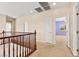 Upstairs hallway with wood railing and access to bedroom at 6741 Kyle Stewart Ct, North Las Vegas, NV 89086