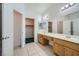 Bathroom boasts double sinks and wood cabinets at 902 Noche De Paz Ave, Henderson, NV 89015