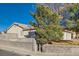 House exterior view, showing a large tree and a block wall at 902 Noche De Paz Ave, Henderson, NV 89015