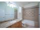 Bathroom with granite countertop, light wood cabinets and bathtub at 8130 Cassian Ct, Las Vegas, NV 89129