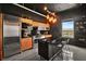 Modern kitchen with wood cabinets, black tile, and island at 200 Hoover Ave # 1502, Las Vegas, NV 89101