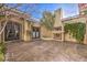 Outdoor patio area with fireplace and lush greenery at 2780 El Camino Rd, Las Vegas, NV 89146