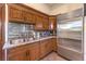 Kitchenette with stainless steel appliances, wood cabinets, and granite counters at 2780 El Camino Rd, Las Vegas, NV 89146