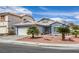 Single-story home with a landscaped yard and two-car garage at 7910 Bridgefield Ln, Las Vegas, NV 89147