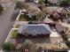 Aerial view of a red house with a gray metal roof, detached garage, and spacious backyard at 3 Avenue K, McGill, NV 89318