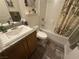 Bathroom with a tub, granite vanity, and wood-look flooring at 380 Hilton Head St, Pahrump, NV 89048