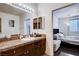 Bathroom with granite vanity, large mirror, and a view of the bedroom at 4129 Fabulous Finches Ave, North Las Vegas, NV 89084