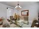 Formal dining room with glass table and chandelier at 4129 Fabulous Finches Ave, North Las Vegas, NV 89084