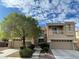 Two-story house with stone accents, double garage, and landscaping at 4129 Fabulous Finches Ave, North Las Vegas, NV 89084