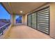 Covered balcony with sliding glass doors and window shades at 10736 Patina Hills Ct, Las Vegas, NV 89135