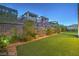 Landscaped backyard with artificial turf and modern fencing at 10736 Patina Hills Ct, Las Vegas, NV 89135