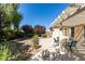 Spacious backyard patio with pergola, seating area, and mature landscaping at 2297 Aria Dr, Henderson, NV 89052