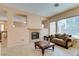 Living room with fireplace, tiled floors, sofas, and a coffee table at 2297 Aria Dr, Henderson, NV 89052