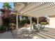 Covered patio with table and chairs, providing shade and an outdoor dining area at 2297 Aria Dr, Henderson, NV 89052