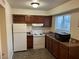 Cozy kitchen with wood cabinets, appliances, and laminate flooring at 501 S Maryland Pkwy St # B7, Las Vegas, NV 89101