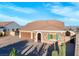 Single story home with three-car garage, paver driveway, and landscaping at 9096 Becket Ranch Ct, Las Vegas, NV 89113