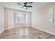 Spacious bedroom with wood-look floors and plantation shutters at 10315 Premia Pl, Las Vegas, NV 89135