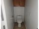 Small, clean bathroom with a toilet and overhead cabinet at 1701 April Shower Pl, Las Vegas, NV 89144