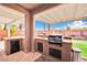 Outdoor kitchen with grill, sink, and mini-fridge at 127 Birch Ridge Ave, Las Vegas, NV 89183