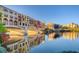 Reflective lake with colorful buildings and mountains in background at 30 Strada Di Villaggio # 215, Henderson, NV 89011