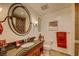 Clean bathroom with granite countertop and large oval mirror at 30 Strada Di Villaggio # 215, Henderson, NV 89011