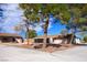 Ranch-style house with covered patio and mature trees at 5820 W La Madre Way, Las Vegas, NV 89130