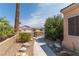 Sidewalk leads to home entrance, passing desert landscaping with rock accents at 1214 Country Club Dr, Laughlin, NV 89029