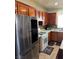 Spacious kitchen with wood cabinets, stainless steel appliances, and tile backsplash at 8178 Rock Meadows Dr, Las Vegas, NV 89178