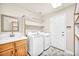 Laundry room with washer, dryer, cabinets and built-in shelving at 9208 November Breeze St, Las Vegas, NV 89123