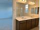 Double vanity bathroom with a large mirror at 744 Monroe Hill Pl, Henderson, NV 89011