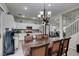 Open concept kitchen with white cabinets, stainless steel appliances, and breakfast bar at 925 Shining Rose Pl, Henderson, NV 89052