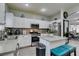 Modern kitchen with island, white cabinets, and stainless steel appliances at 925 Shining Rose Pl, Henderson, NV 89052