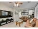 Comfortable living room with brown sofas and a large TV at 925 Shining Rose Pl, Henderson, NV 89052