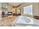 Main bathroom with corner soaking tub, double vanity and tile floors at 10668 Porta Romana Ct, Las Vegas, NV 89141